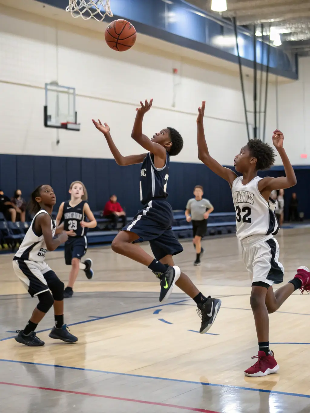 A dynamic image of people playing basketball indoors, showcasing teamwork and physical activity in a well-lit gymnasium at STEP BY STEP.